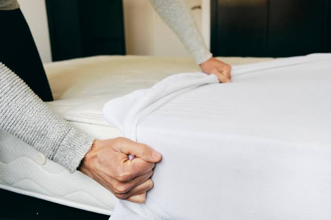 how often a mattress protector should be washed